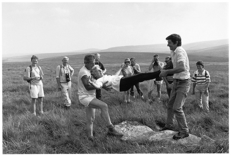 Eileen Clarke being bounced on a boundary stone, Throwleigh Beating the Bounds 1991.jpg